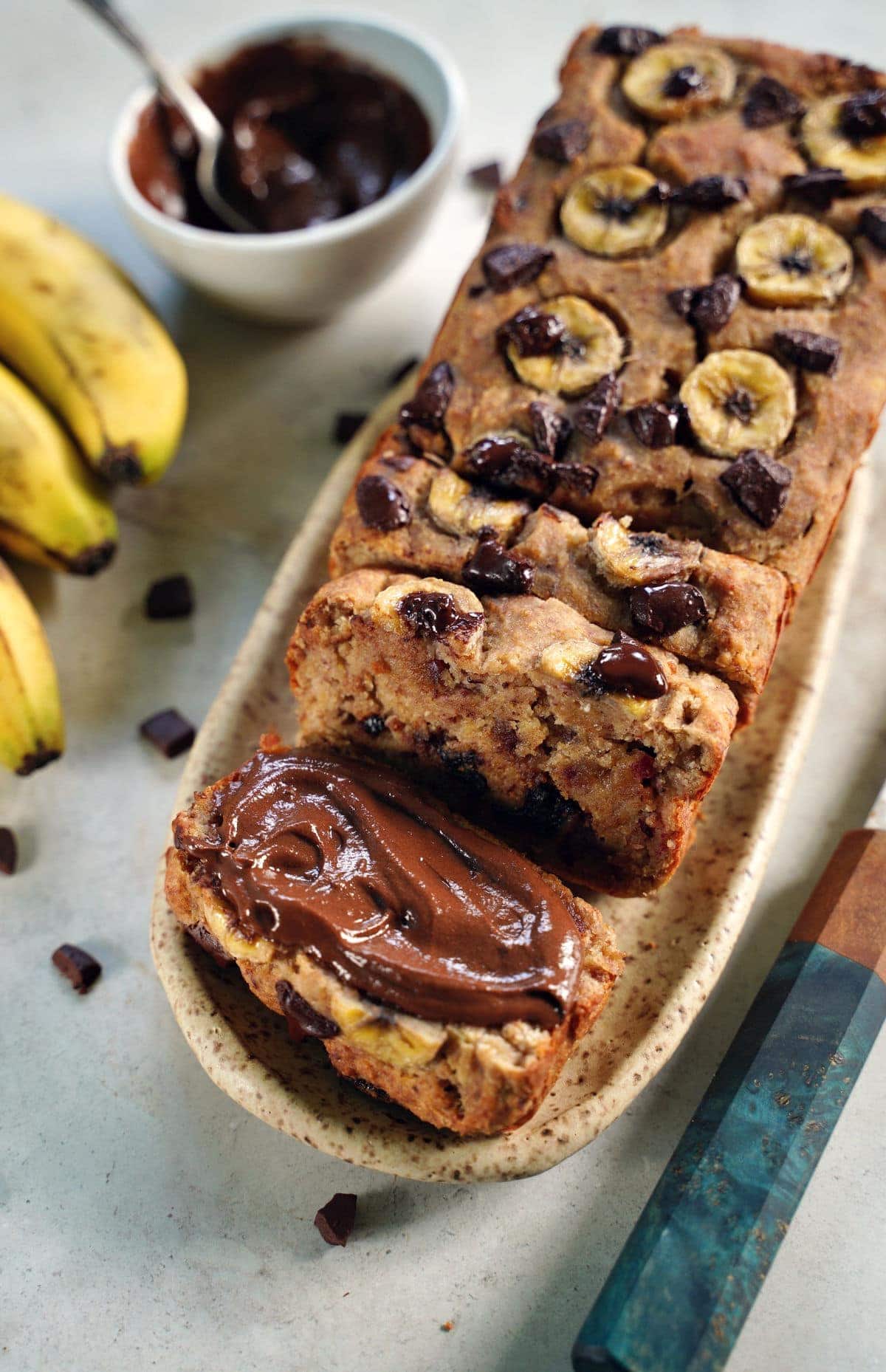 gluten-free banana bread with vegan chocolate spread on one slice