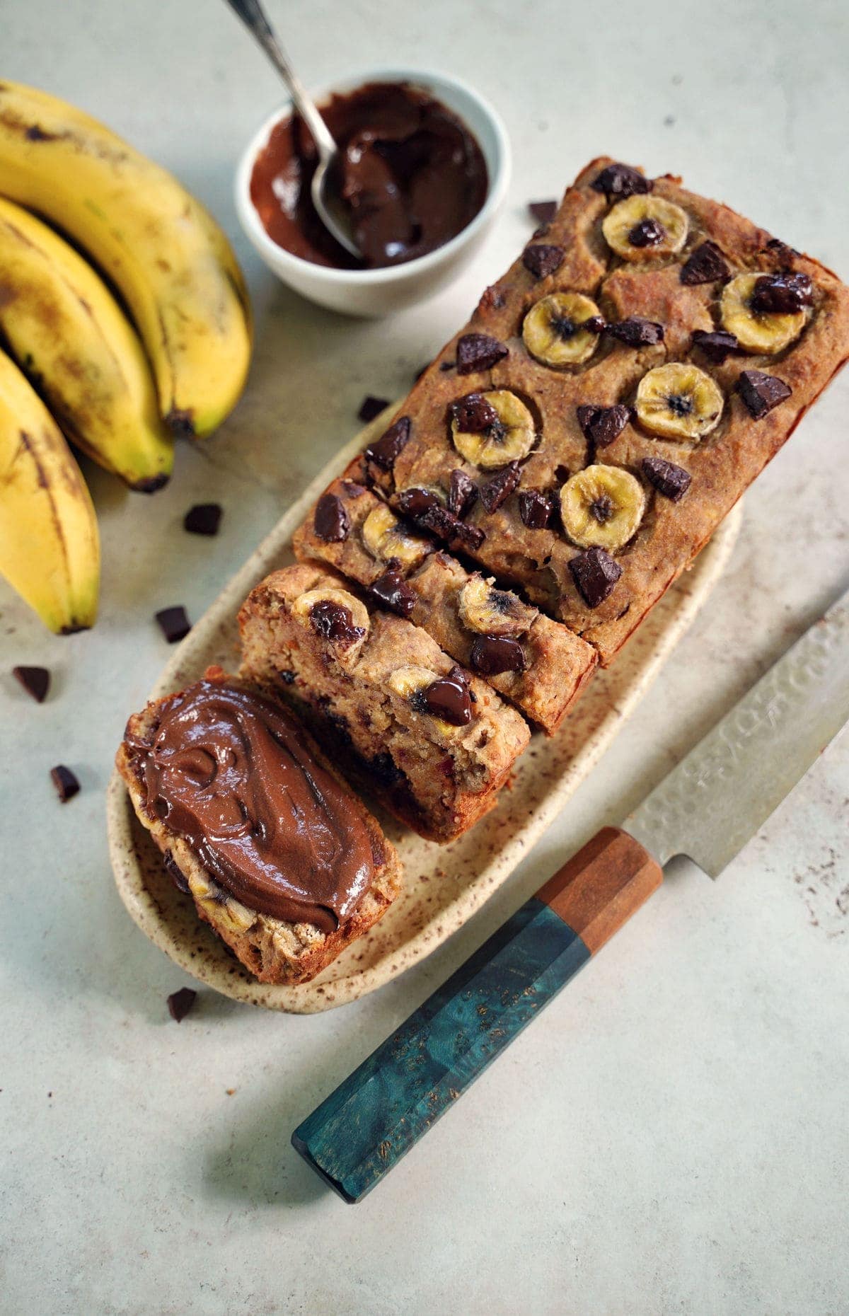 healthy banana bread one slice topped with chocolate spread