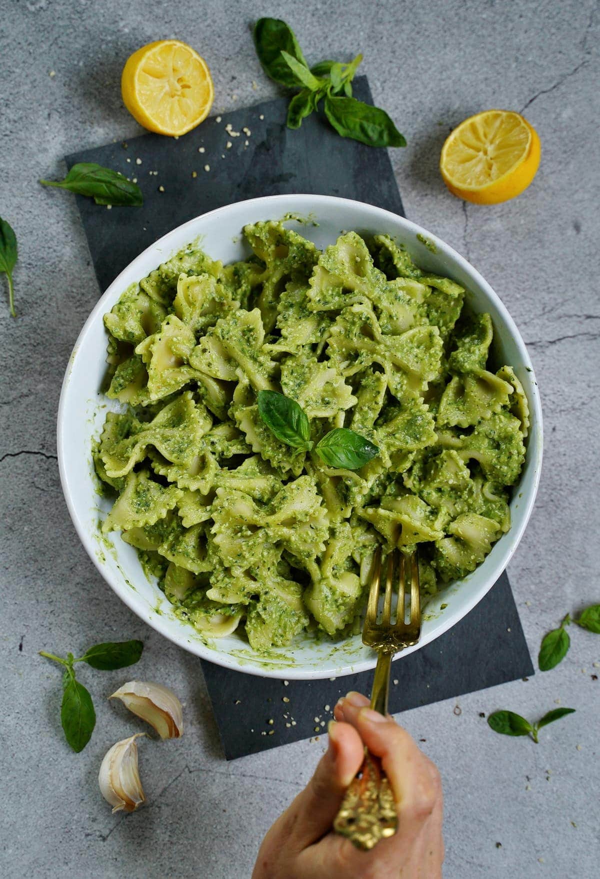 avocado pesto pasta with basil in bowl from above