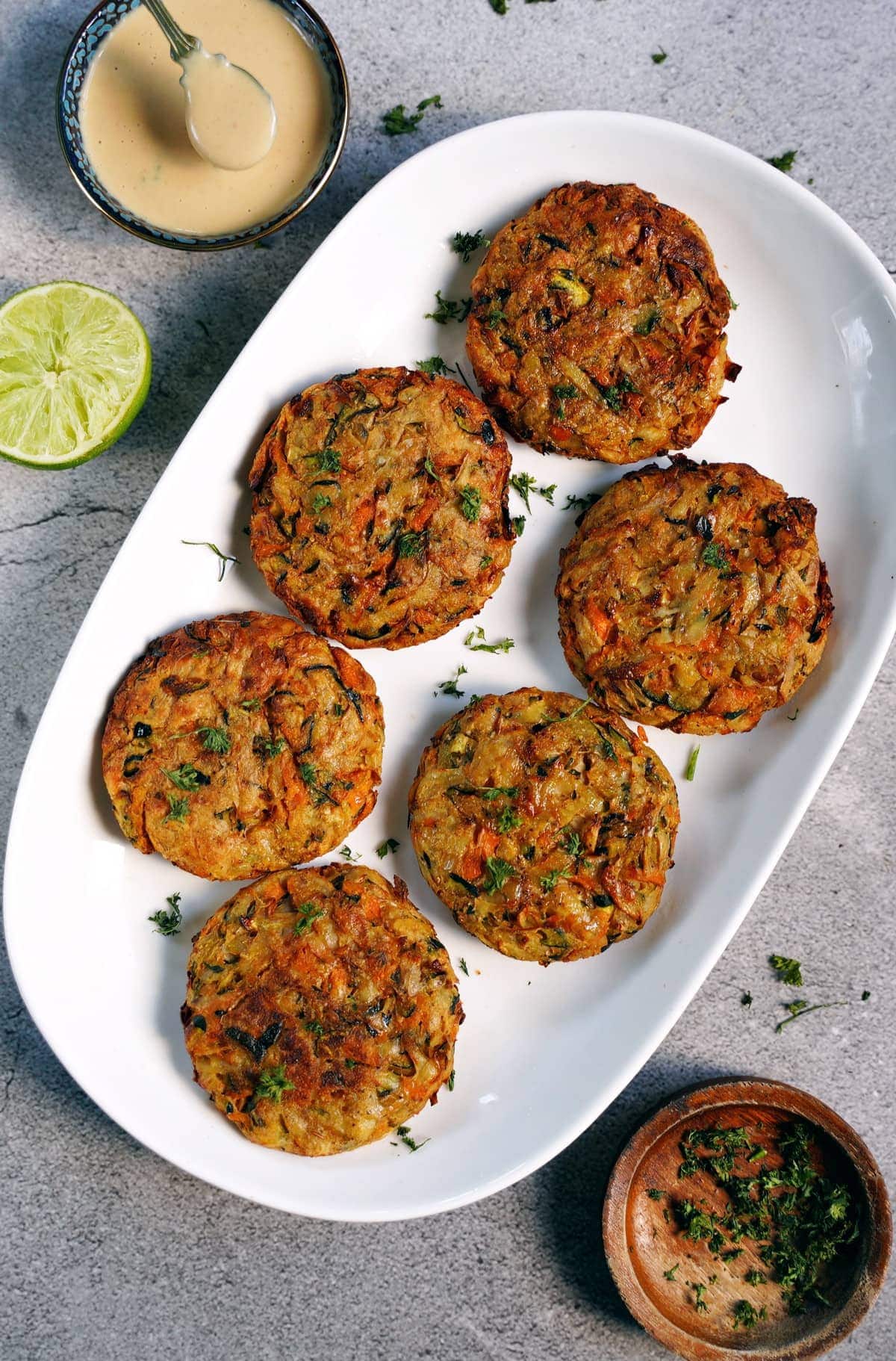 6 vegetable fritters on white plate from above