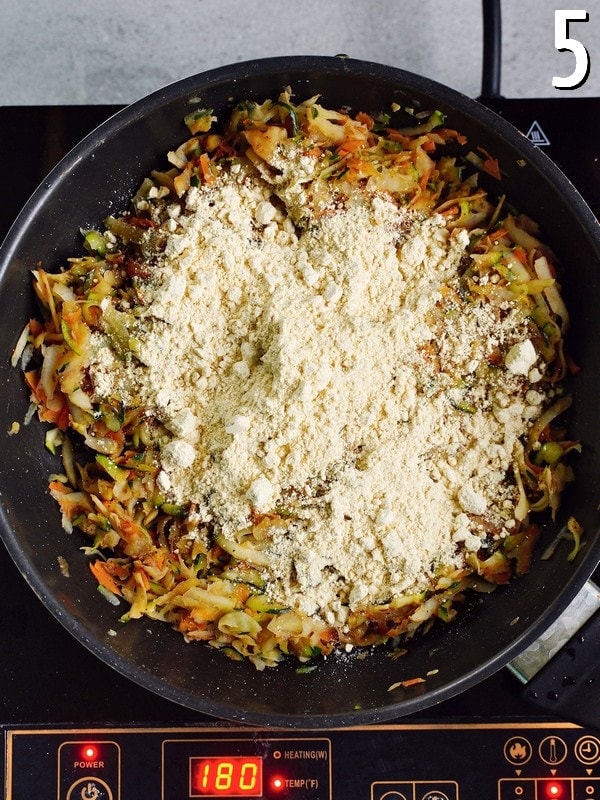 grated veggies with chickpea flour in black skillet