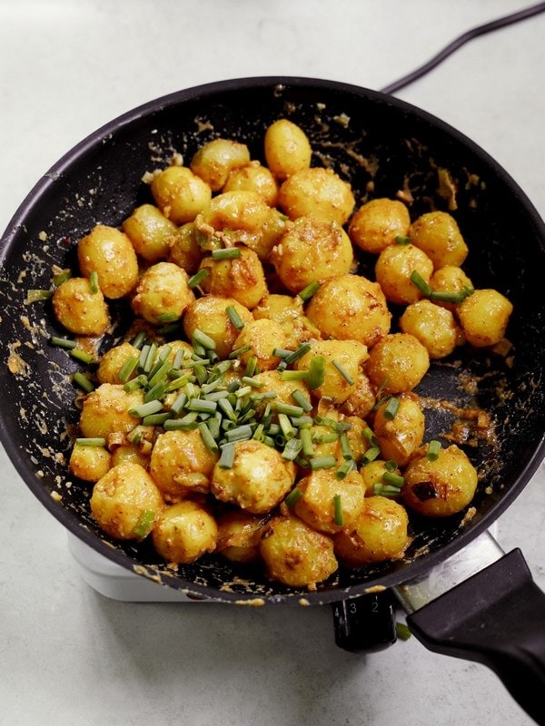 new potatoes with chives in black skillet