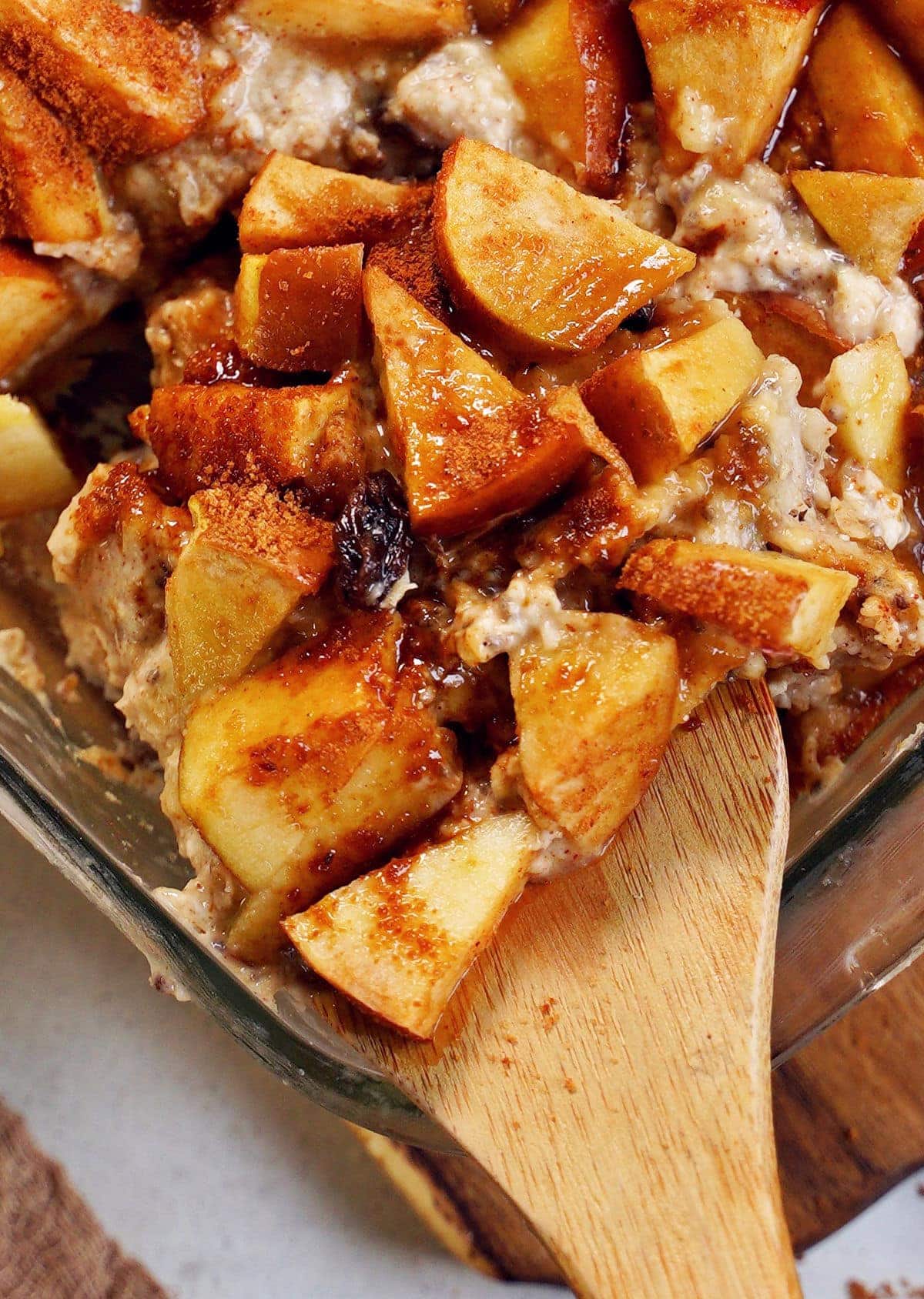 close-up of baked apple oatmeal on wooden spoon