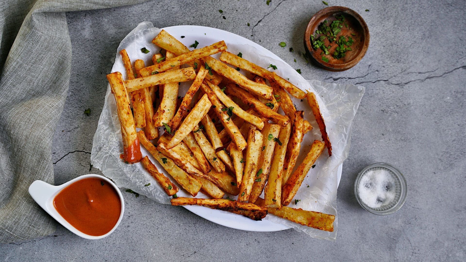 horizontal shot of yuca fries with red dip