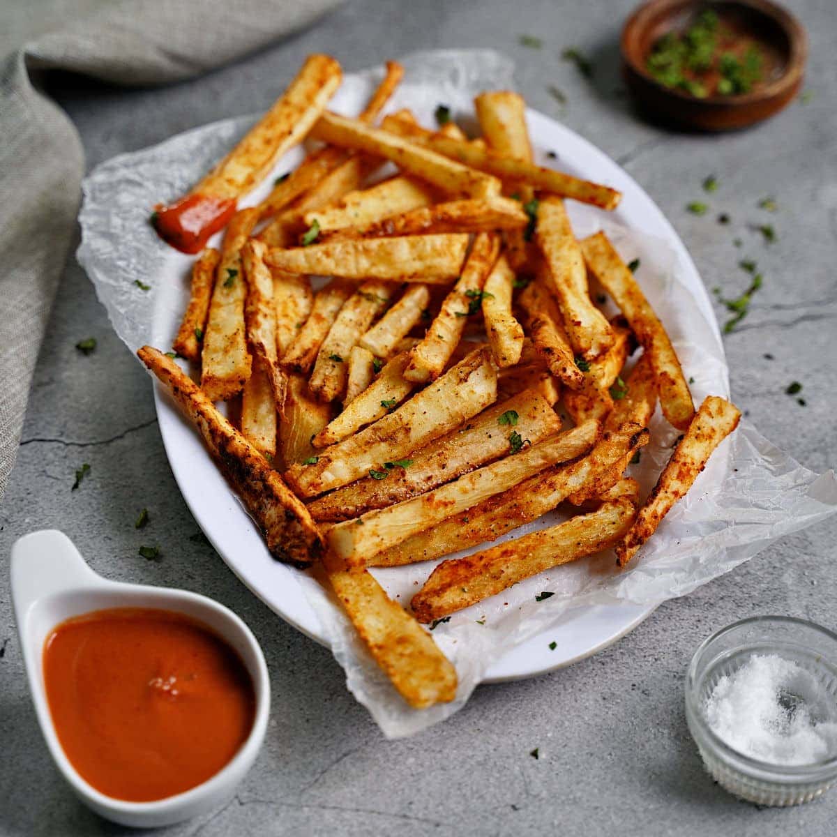side shot of cassava fries with red dip