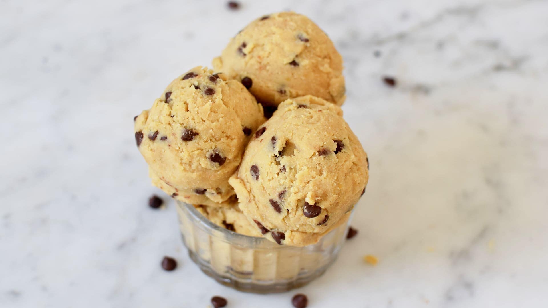 Horizontal shot of scoops of vegan cookie dough with chocolate chips