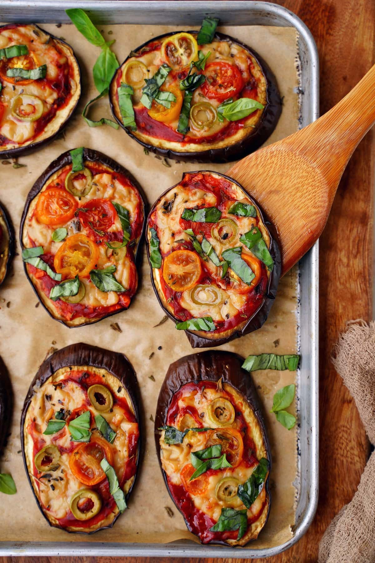 top shot of eggplant pizza slices on baking sheet