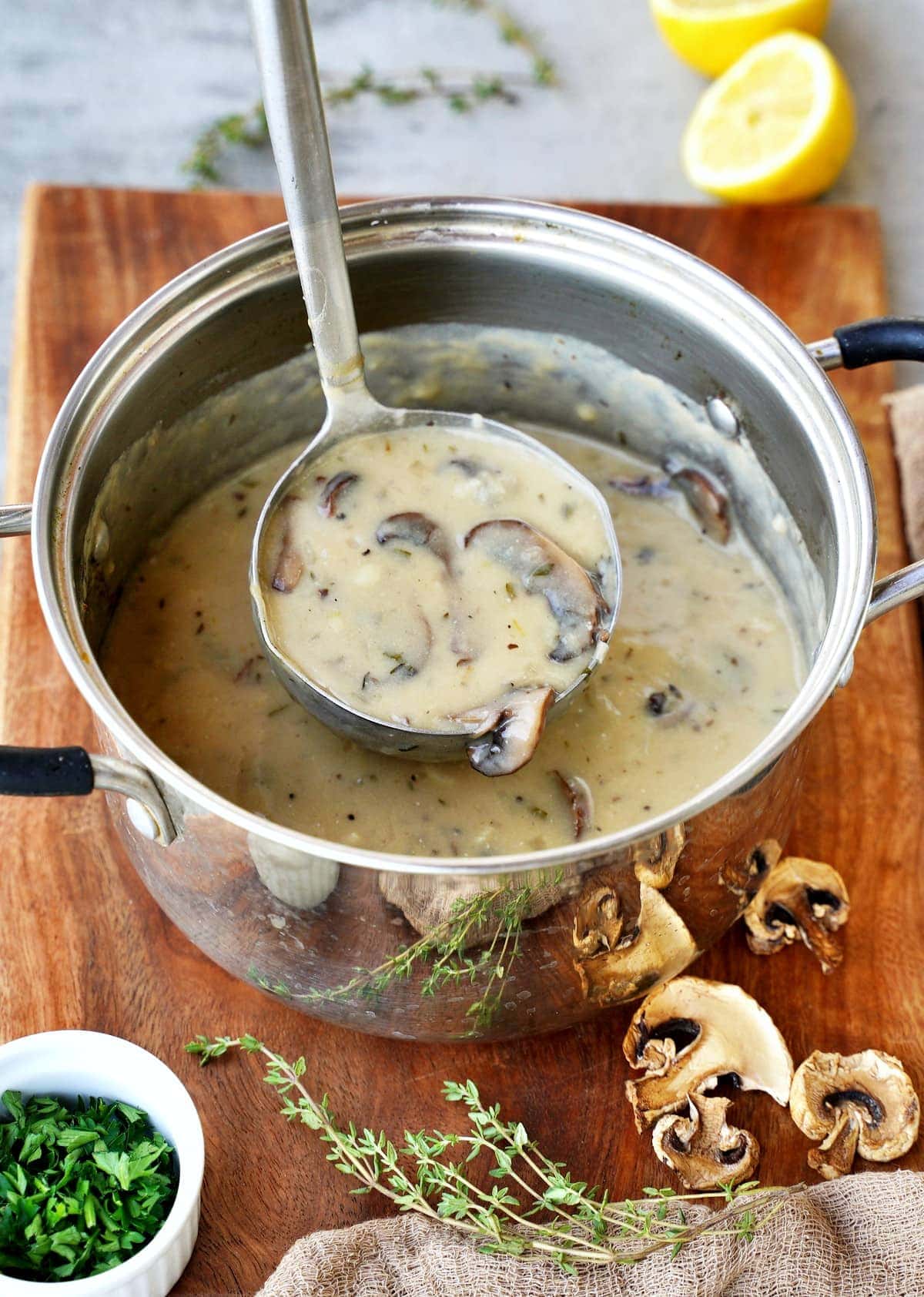 vegan cream of mushroom soup in pot with ladle
