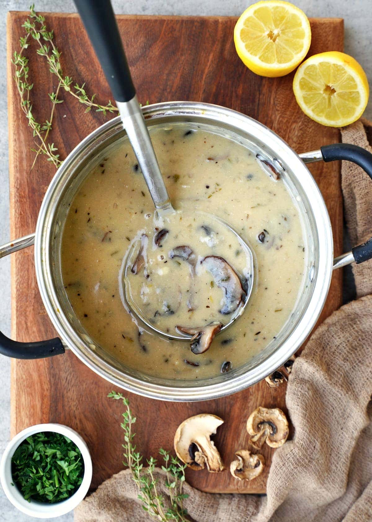 vegan mushroom soup in pot with ladle