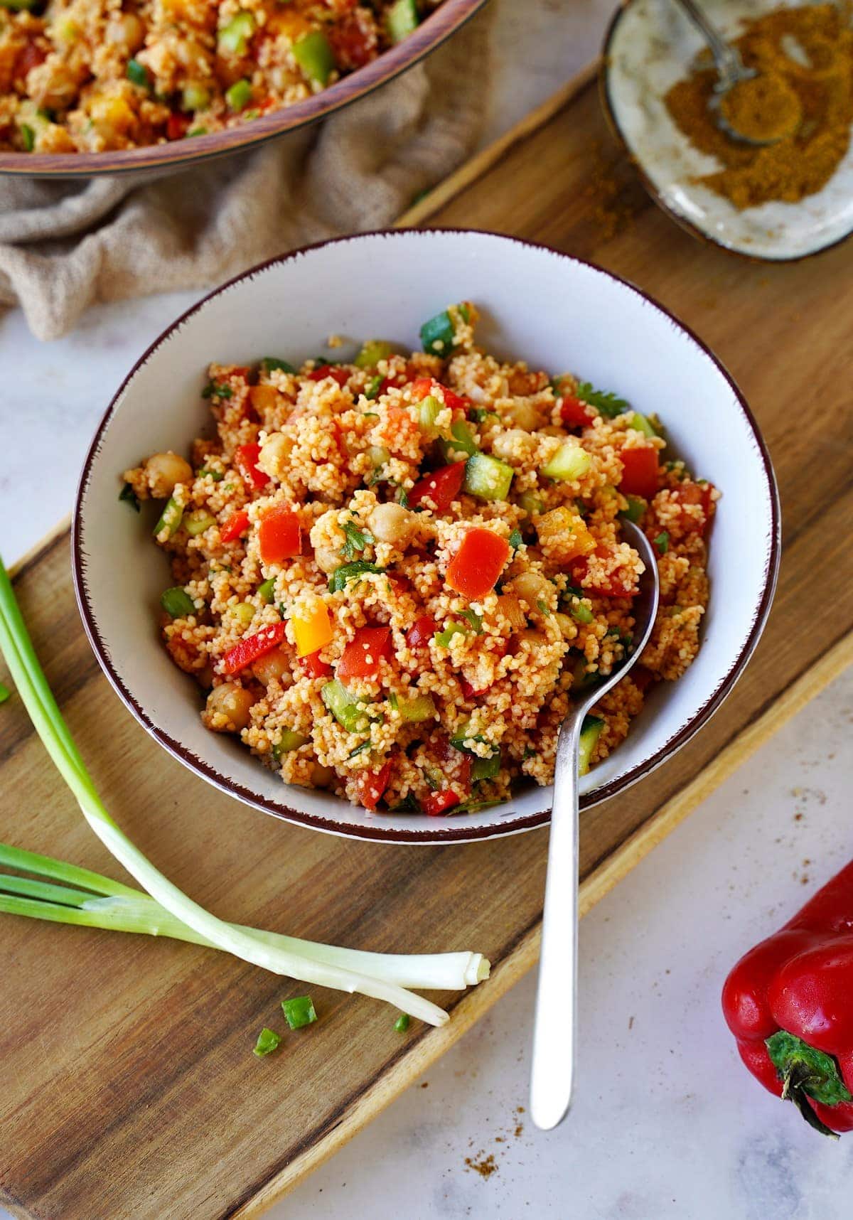 Moroccan couscous salad in bowl with spoon