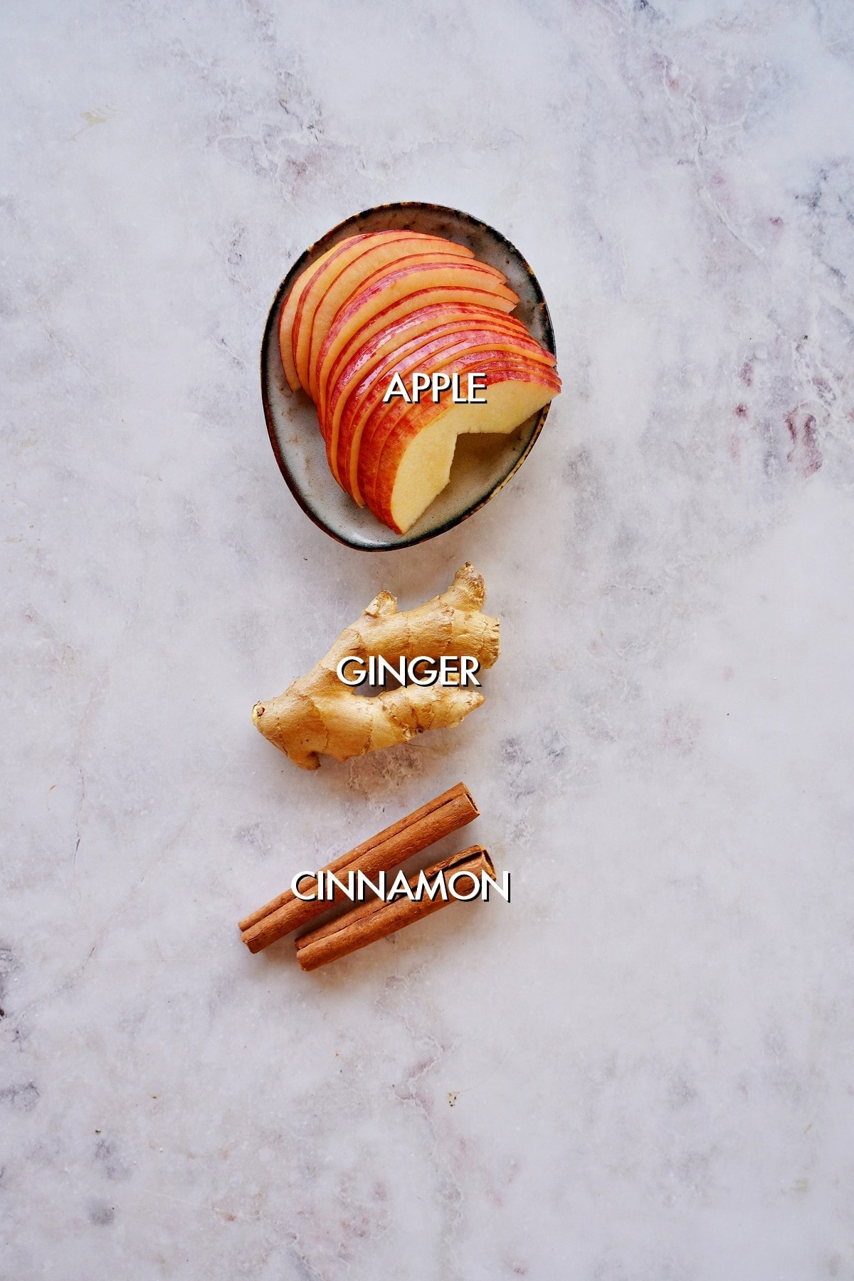 apple, ginger and cinnamon on white backdrop
