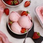 creamy vegan strawberry ice cream in small bowl with spoon