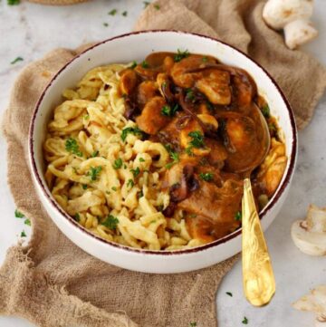 vegan spaetzle with mushrooms and gravy in bowl