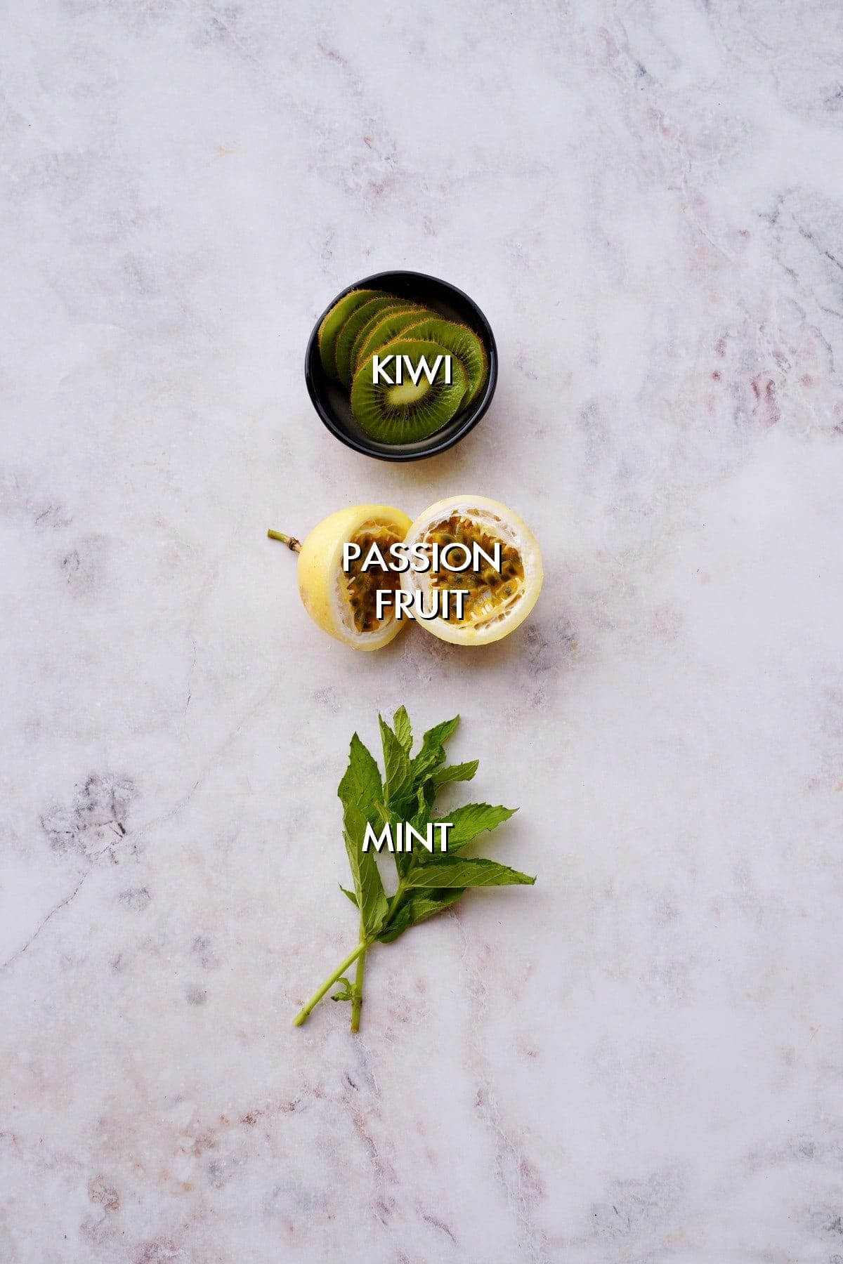 kiwi, passion fruit, mint on white backdrop