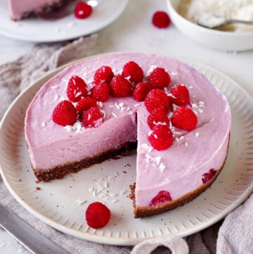no-bake raspberry cheesecake with a slice cut out