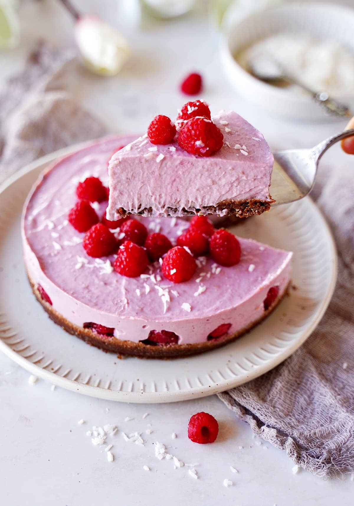 presenting a slice of no-bake raspberry cheesecake