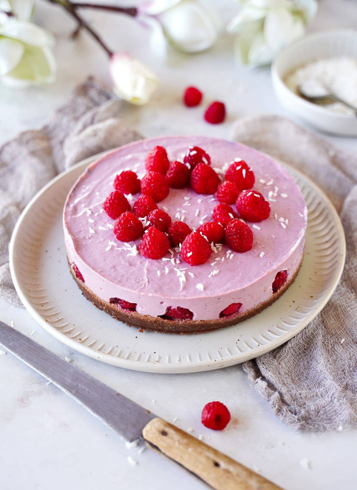 whole no-bake cheesecake with raspberries
