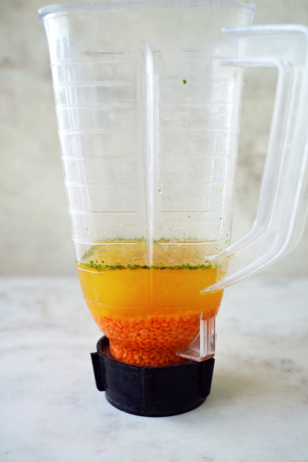 soaking red lentils in veggie broth in blender