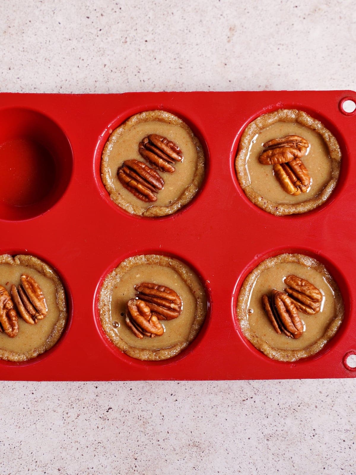 tartlets topped with pecans before baking