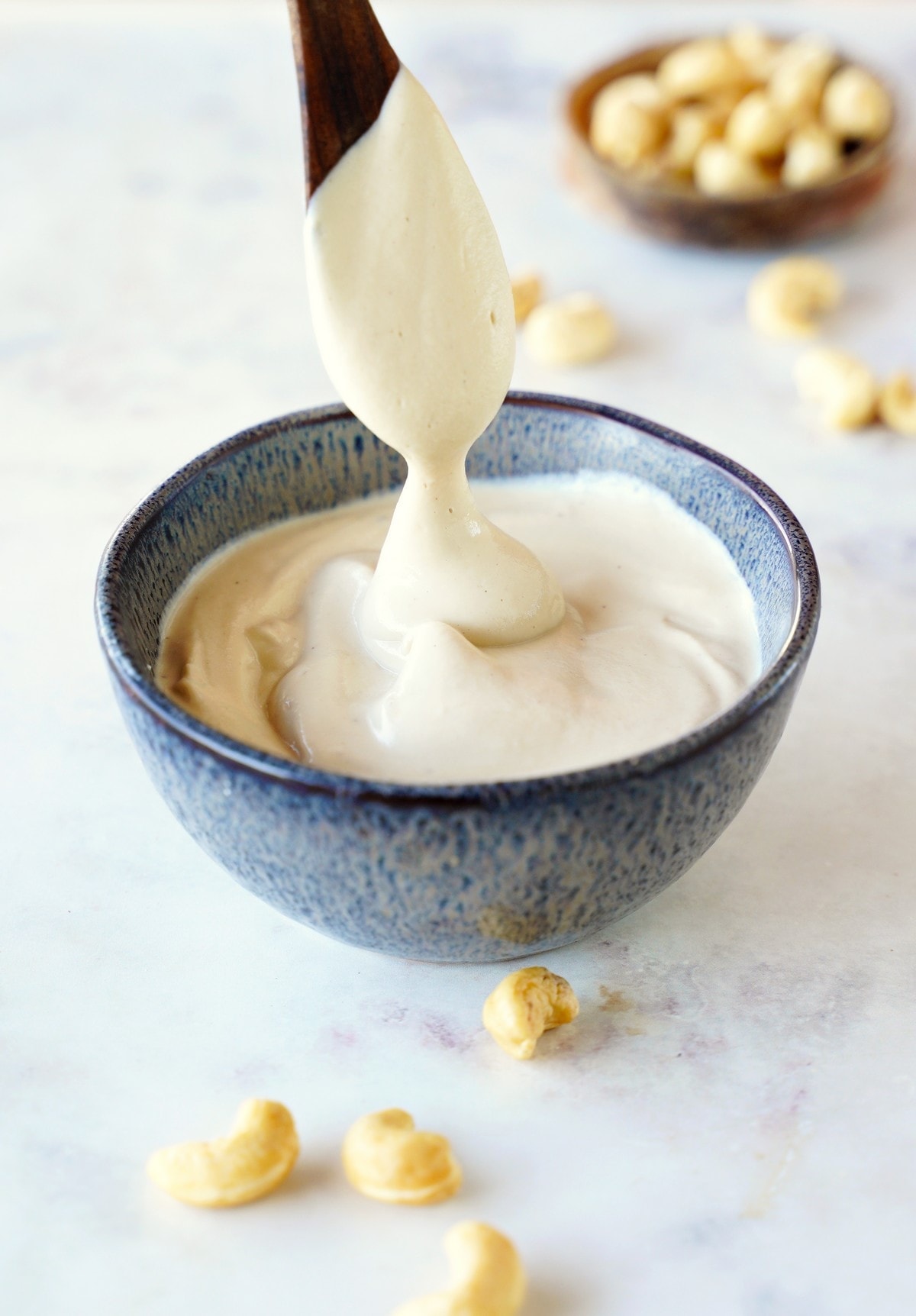 cashew cream in blue bowl with spoon
