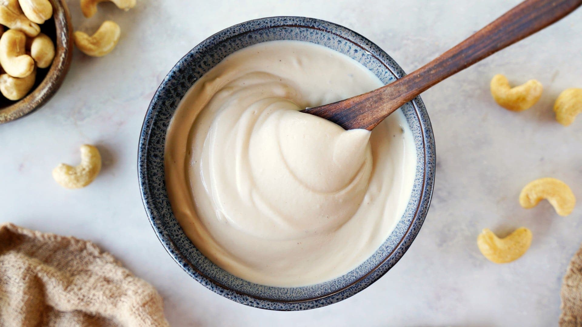 horizontal shot of cashew cream in bowl with spoon