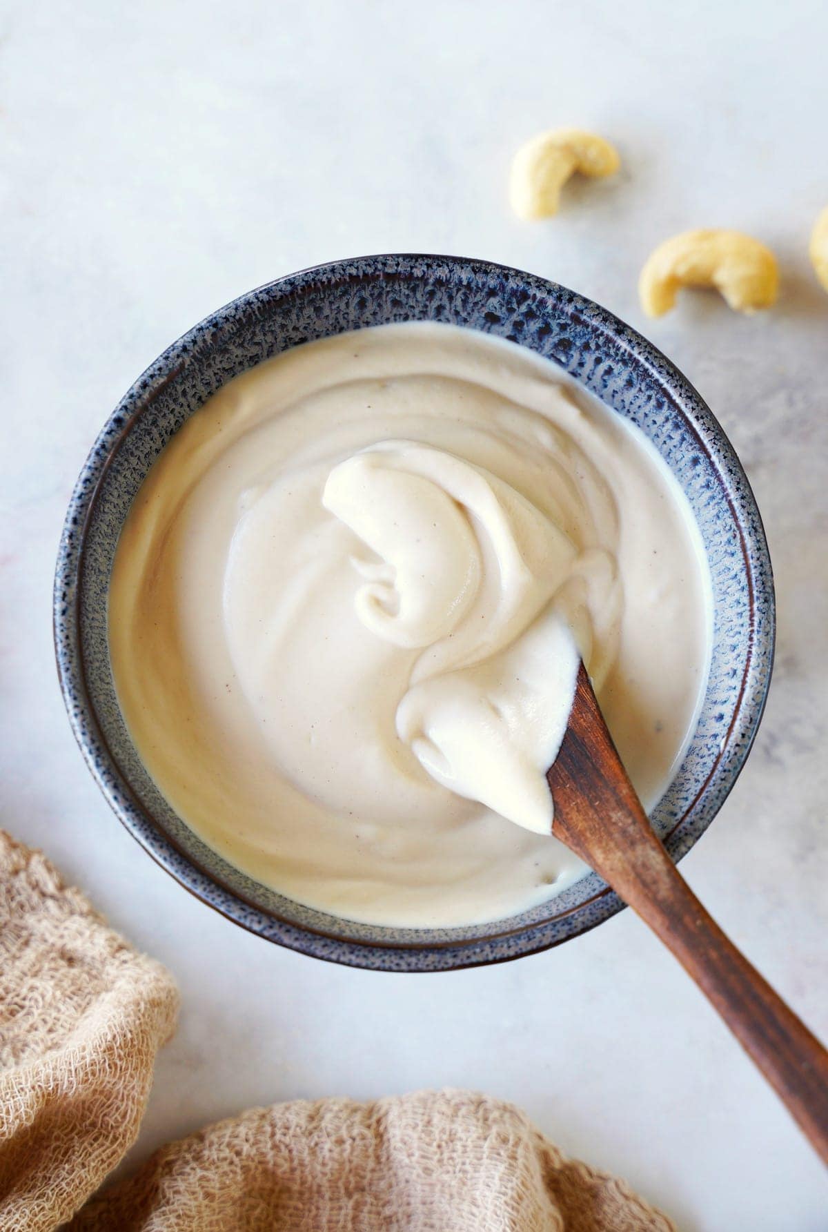 top shot of cashew cream in bowl with spoon