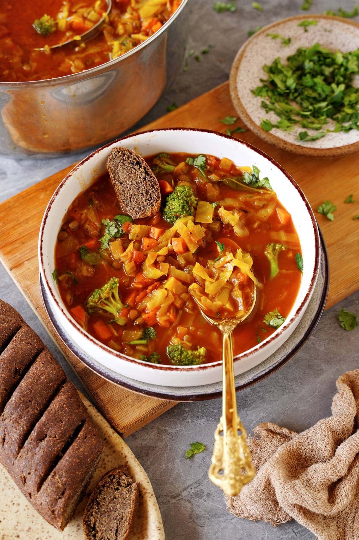 vegan cabbage soup in bowl with bread