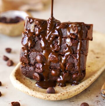 drizzling chocolate over sliced chocolate pumpkin bread