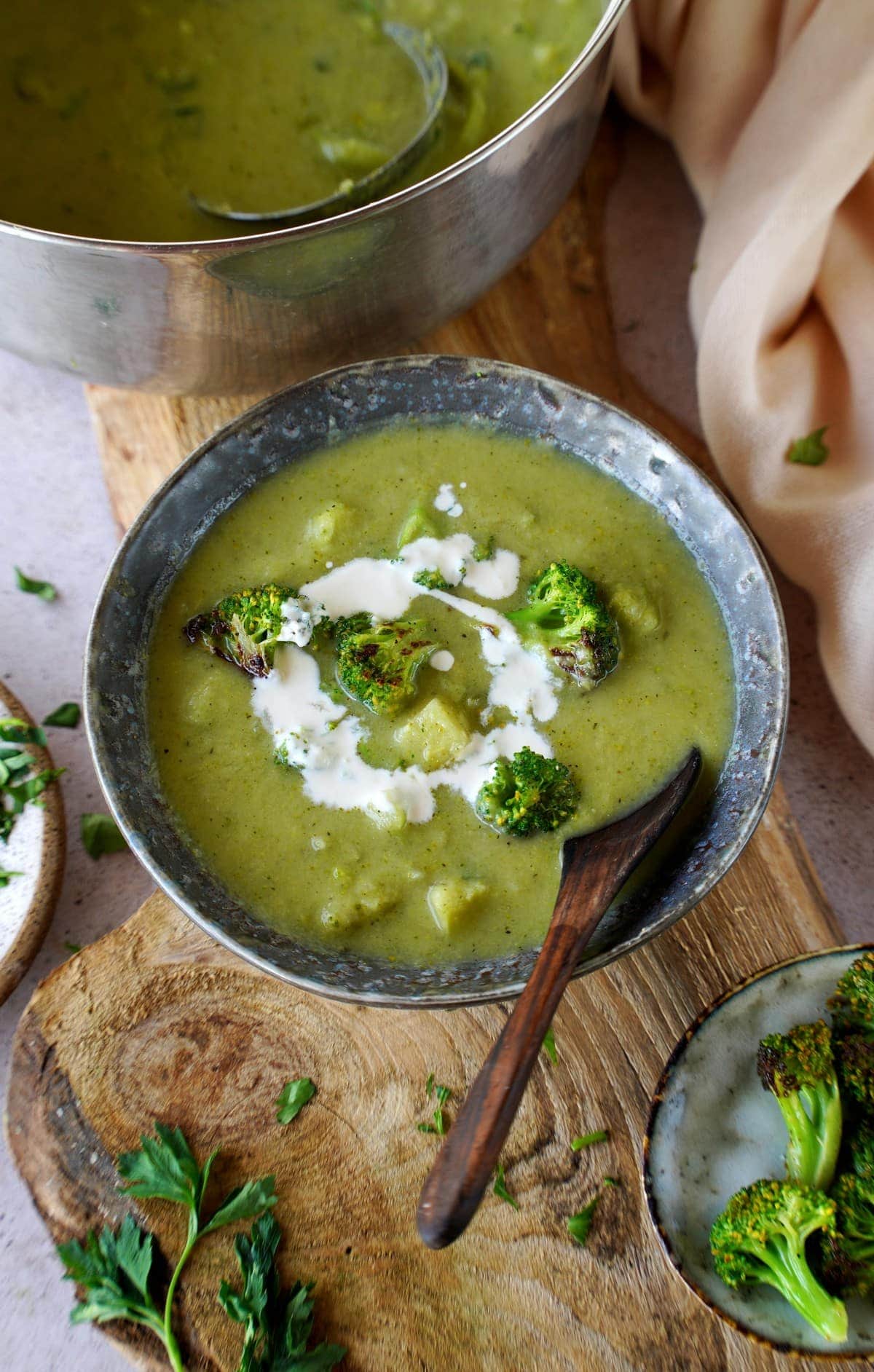 creamy vegan broccoli soup in bowl with spoon