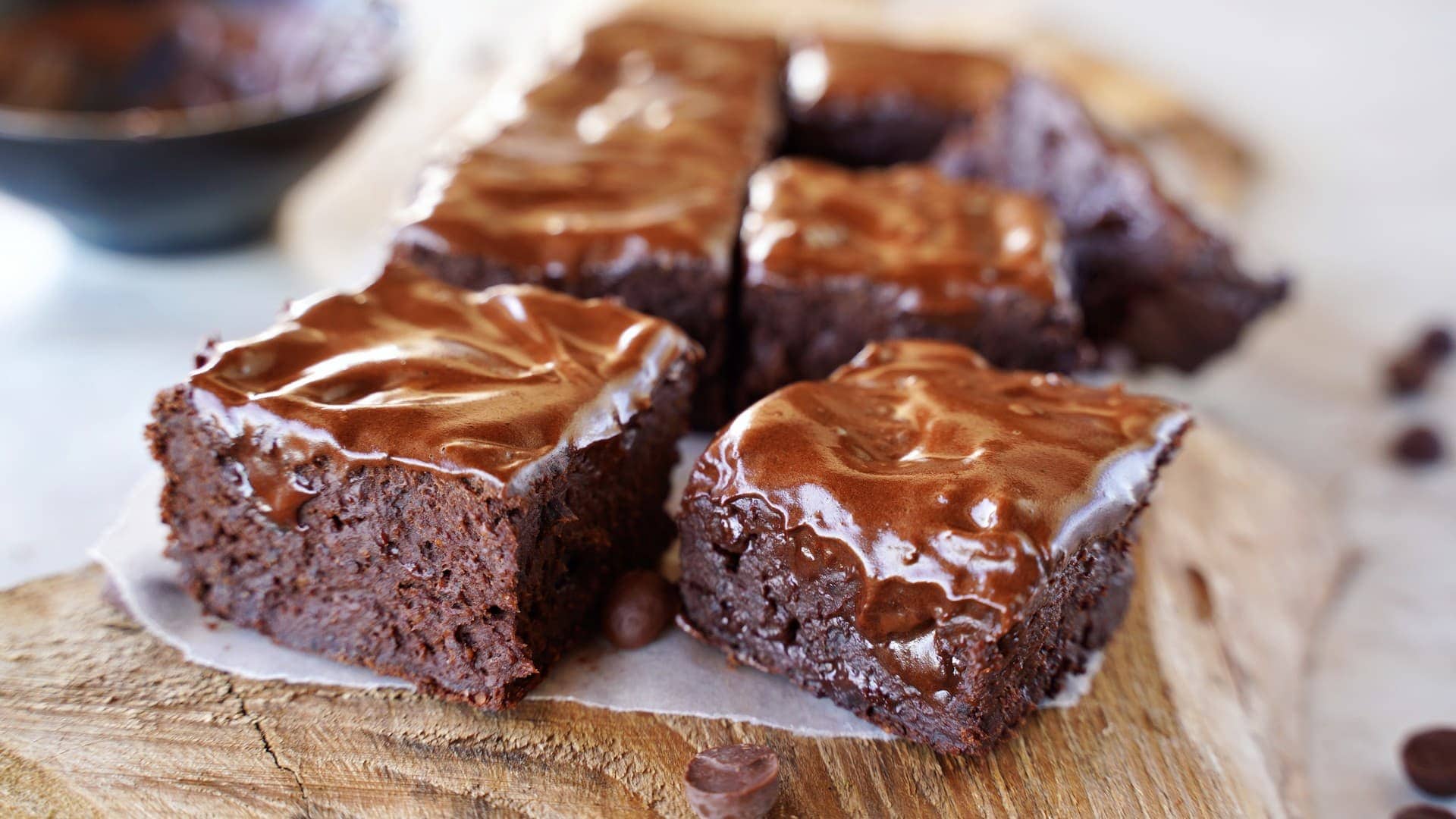 horizontal shot of black bean brownies with vegan chocolate cream on top