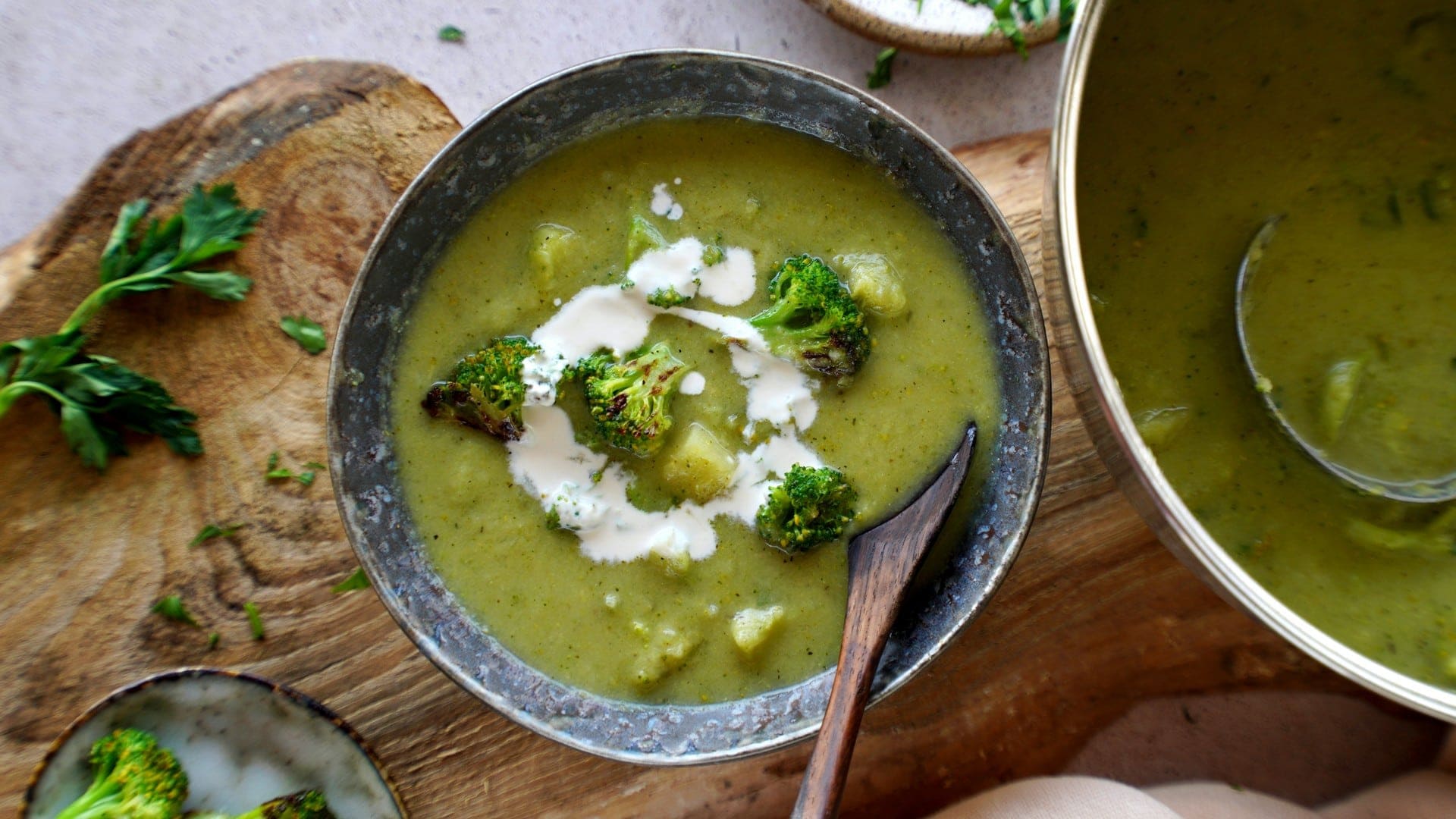 horizontal shot of broccoli soup in bowl with spoon