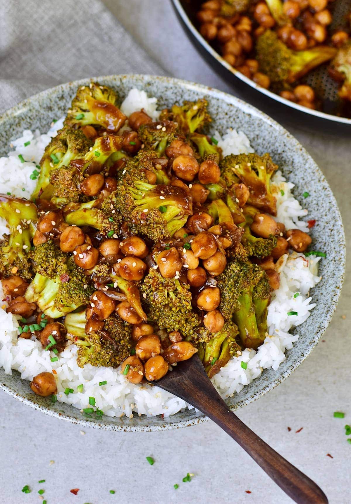 Garlic broccoli stir-fry with chickpeas over rice in bowl