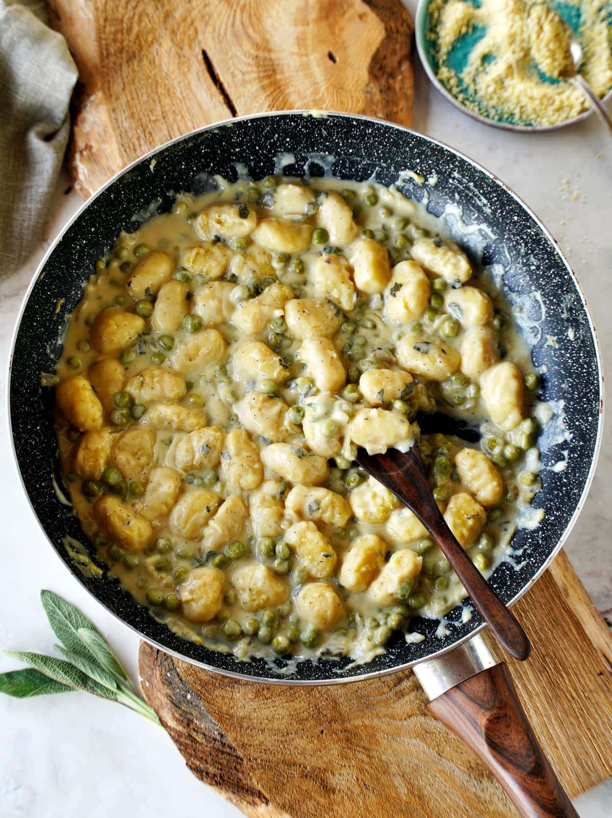 gnocchi with creamy white sauce in skillet