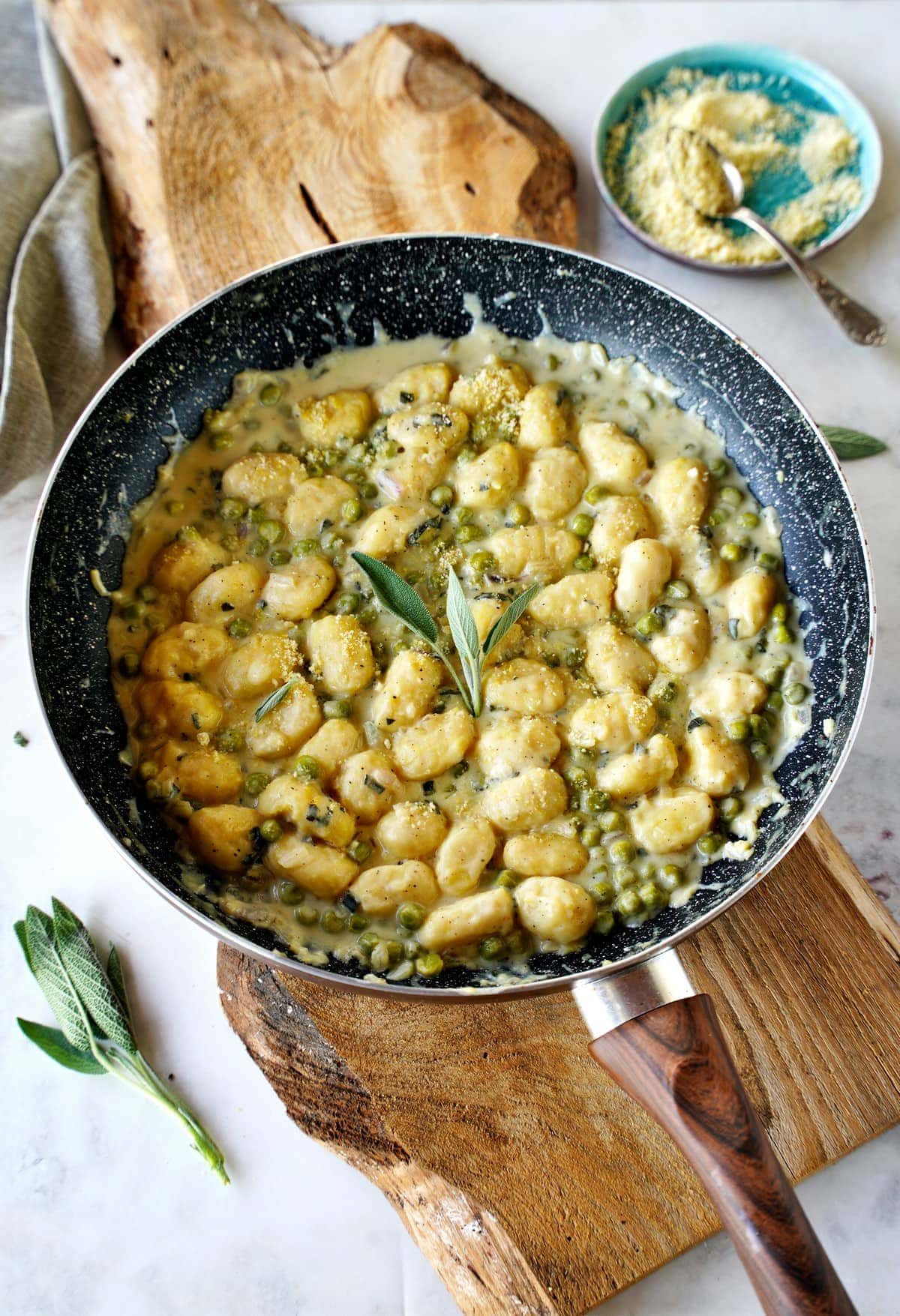 sage gnocchi with peas in skillet