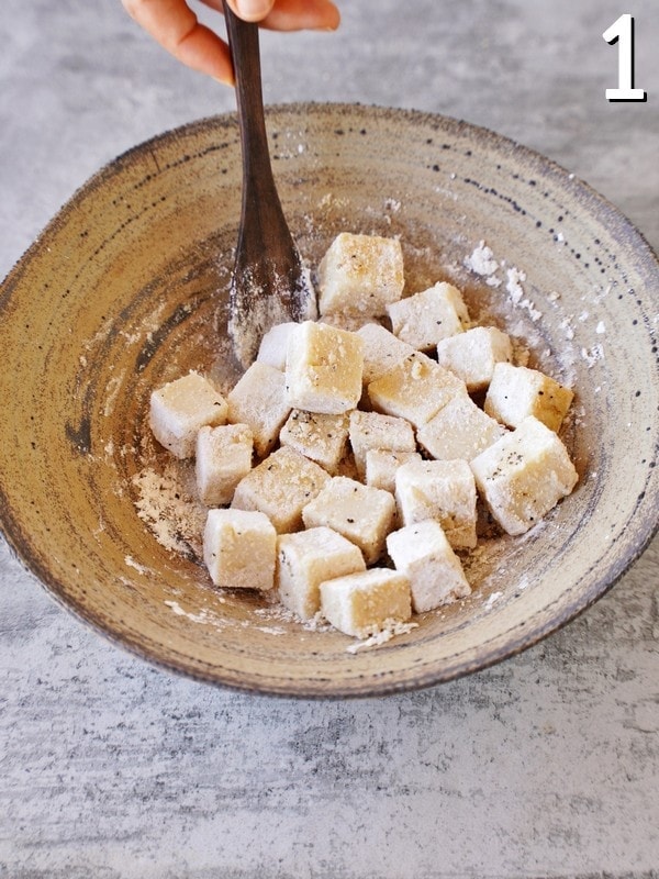 chickpea tofu cubes in bowl covered in starch