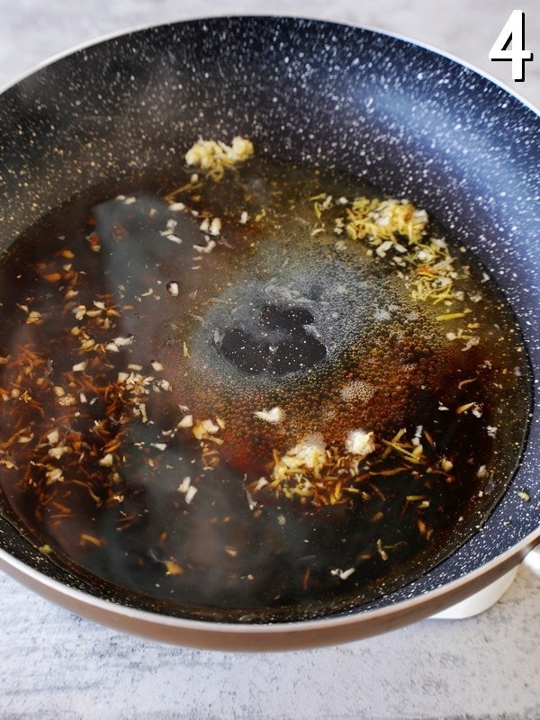 sauce ingredients with garlic and ginger in black skillet