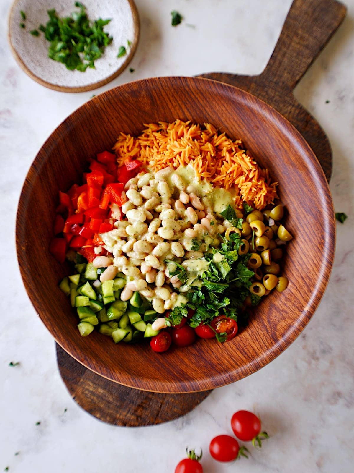 top shot of salad ingredients in bowl before tossing
