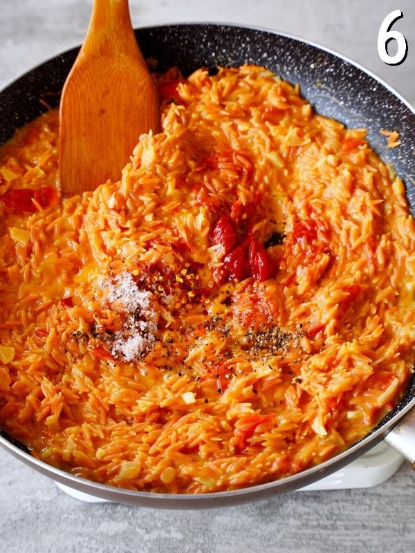 red lentil orzo with tomato paste and spices in pan