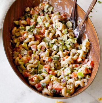 vegan pasta salad in wooden bowl with healthy dressing