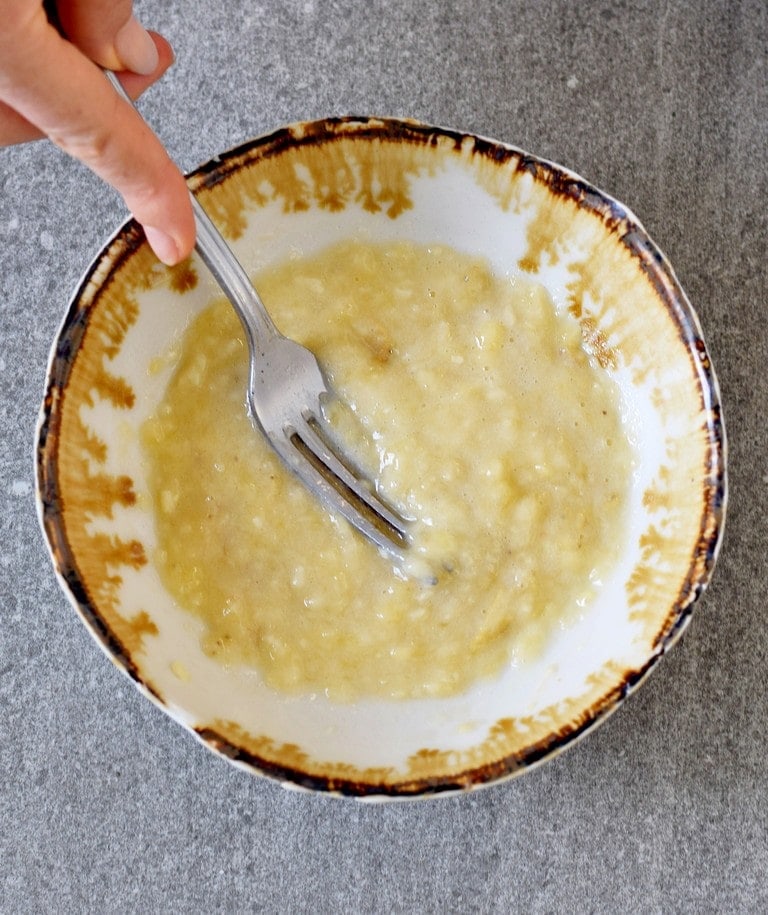 banana mashed with fork in bowl