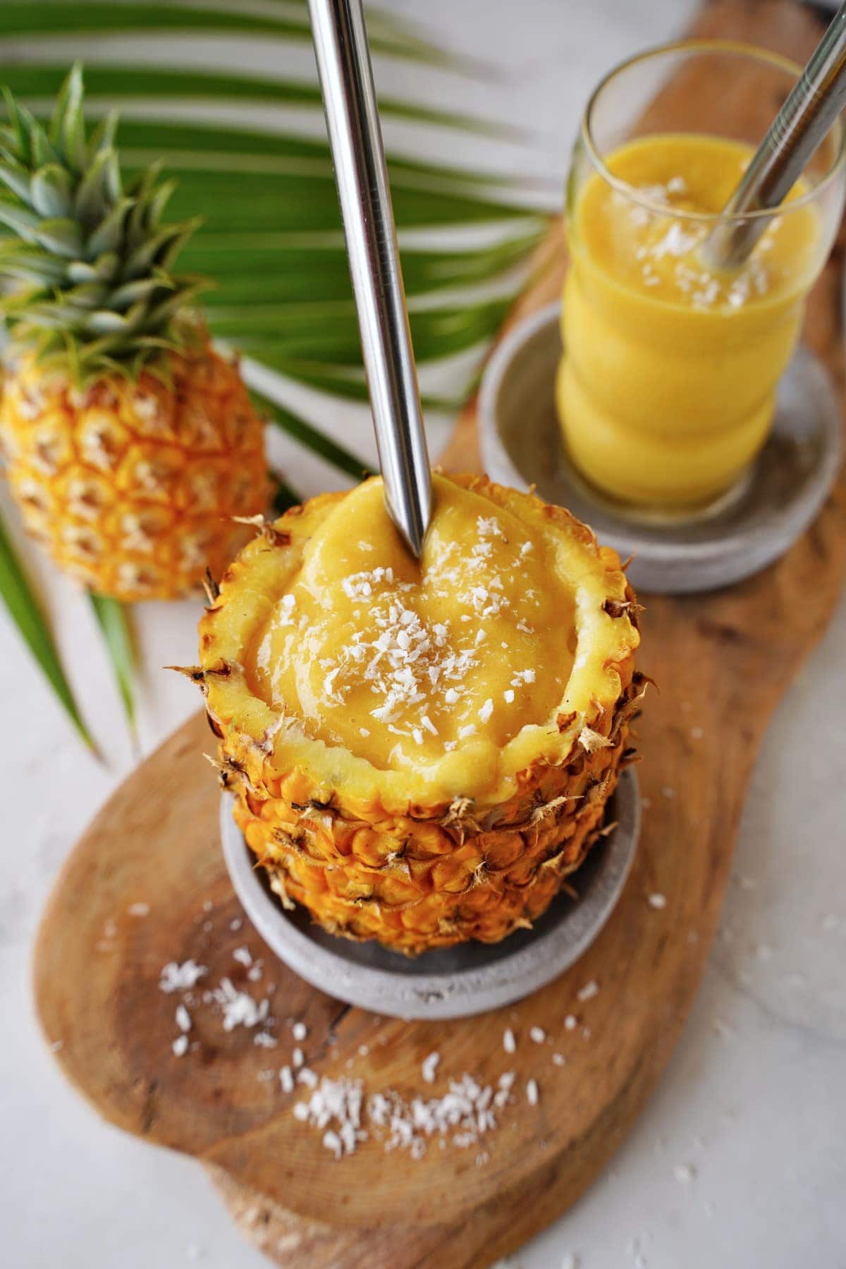 pineapple mango smoothie served in pineapple
