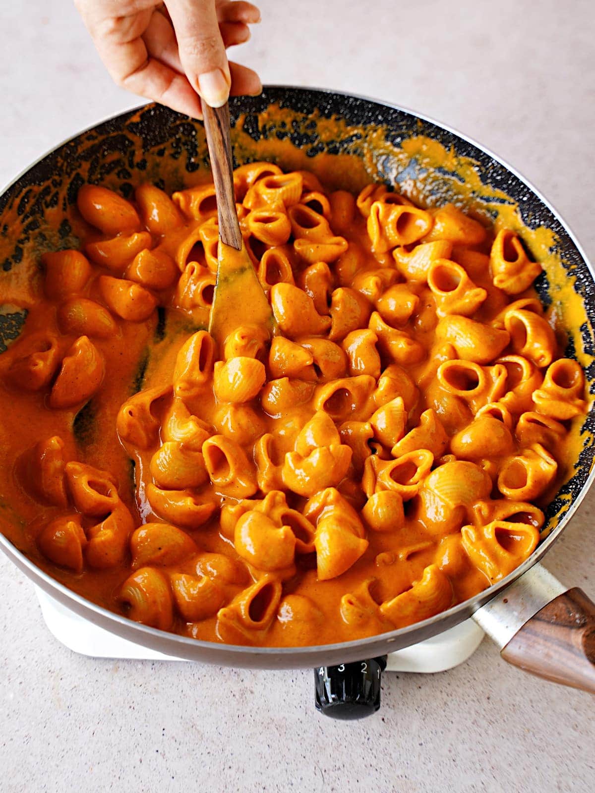 orange sauce with pasta in skillet