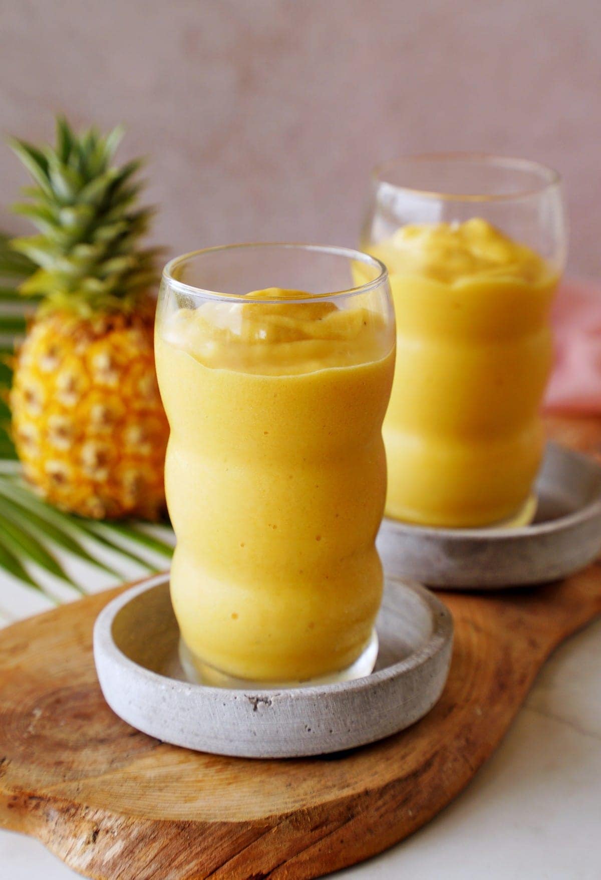 thick frozen tropical smoothie in 2 glasses