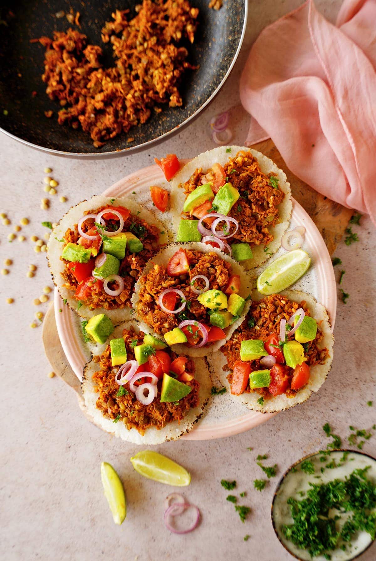 lentil tacos with tomato, onion, and avocado on plate