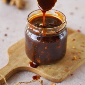 Korean bbq sauce in jar with spoon on wooden board
