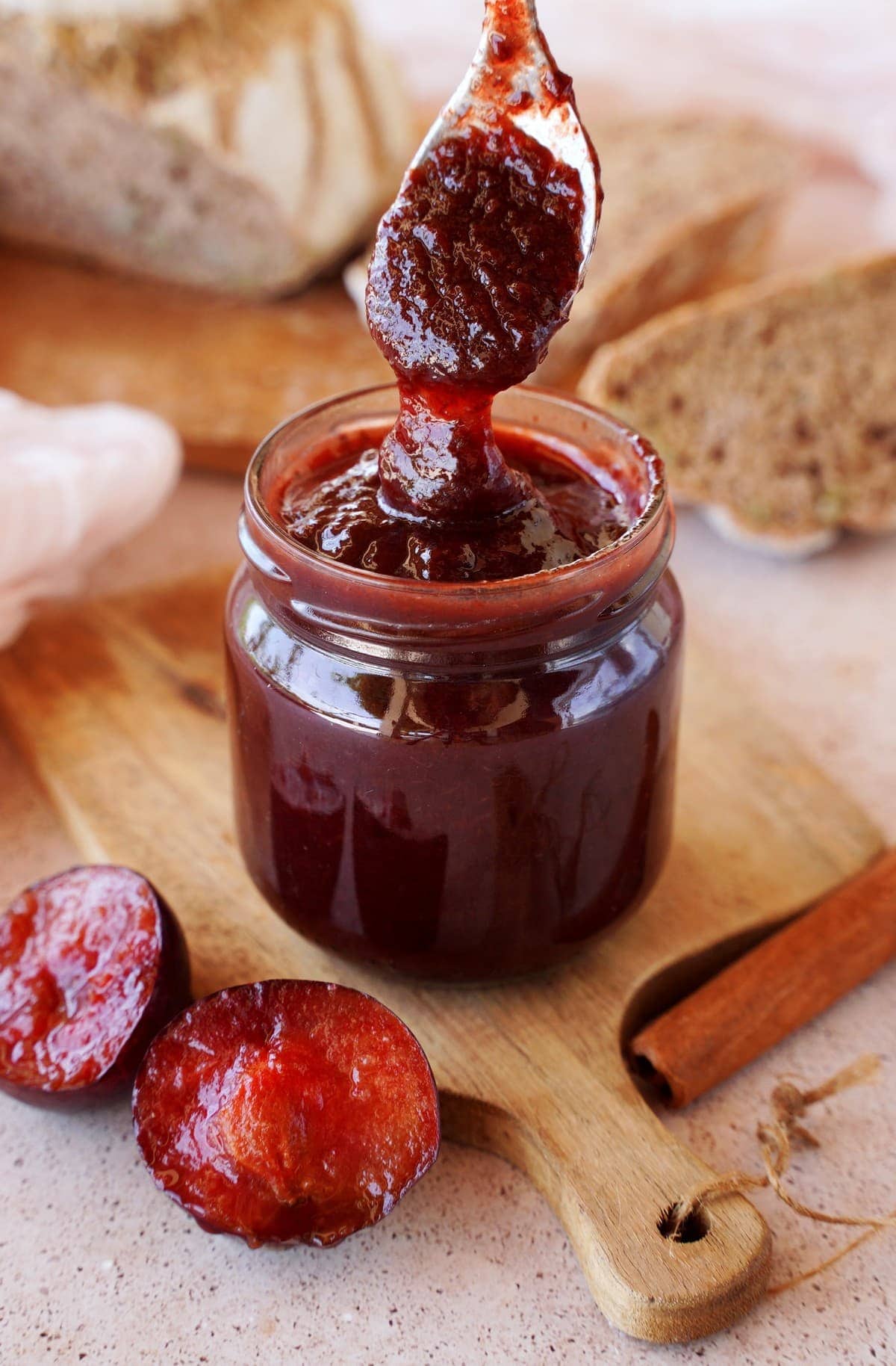 plum jam in jar with spoon