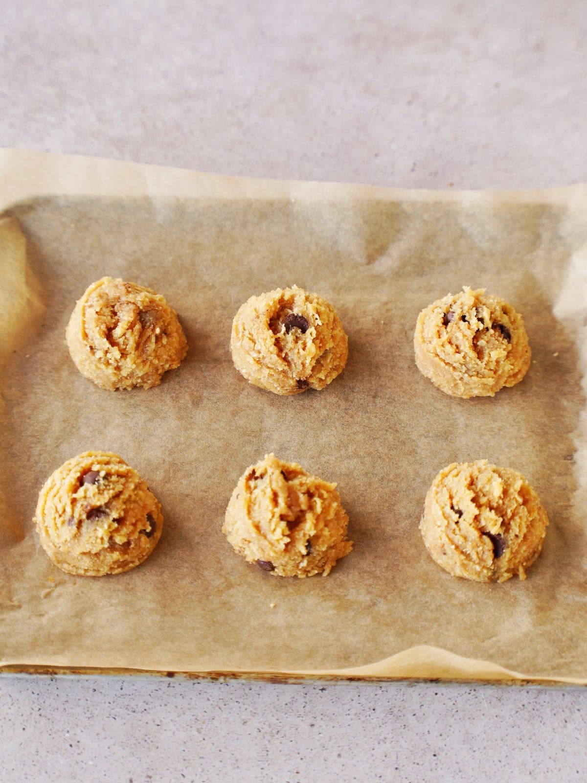 6 gluten-free cookies before baking on parchment paper