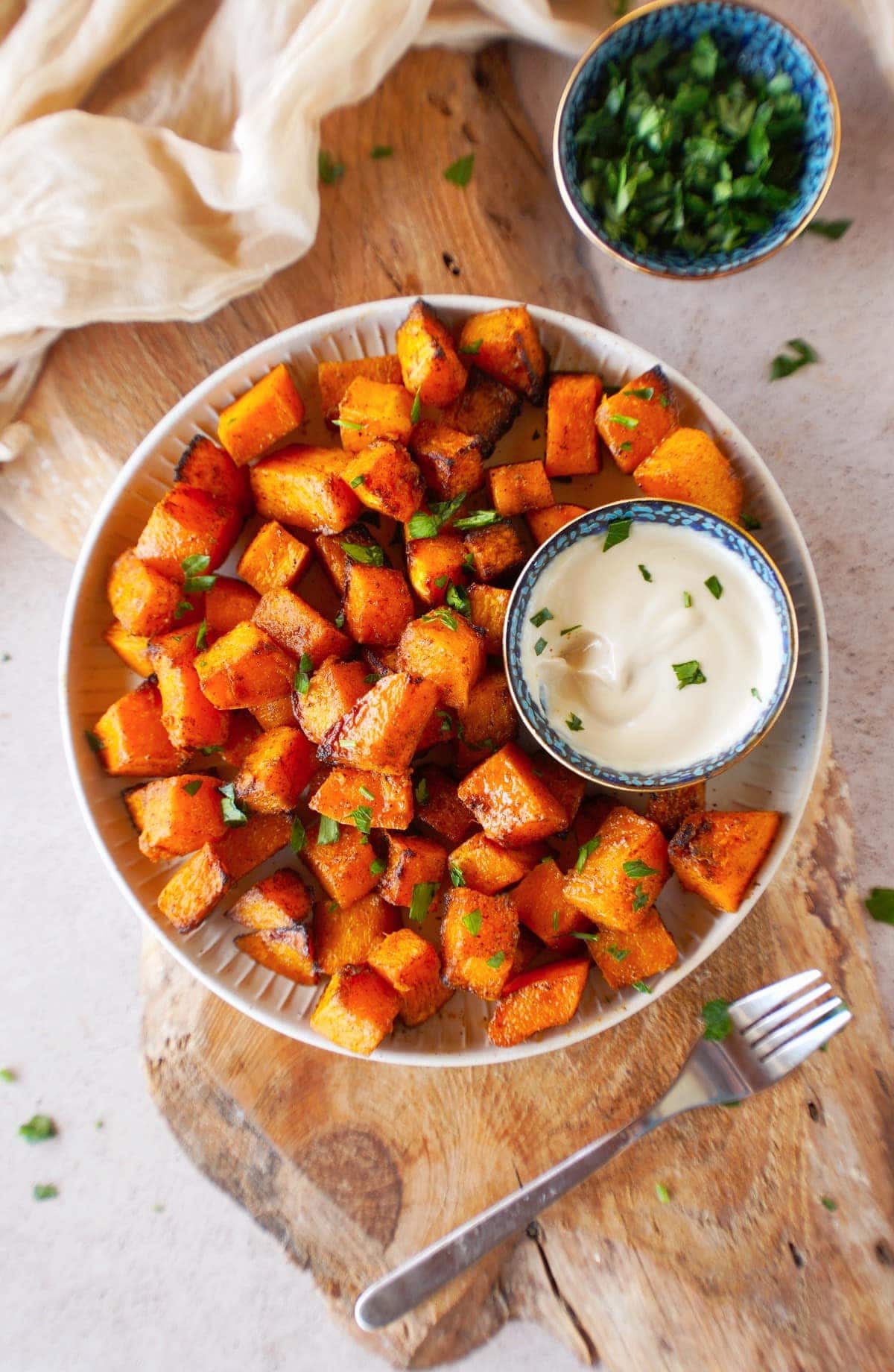 air fried butternut squash on plate with white dip