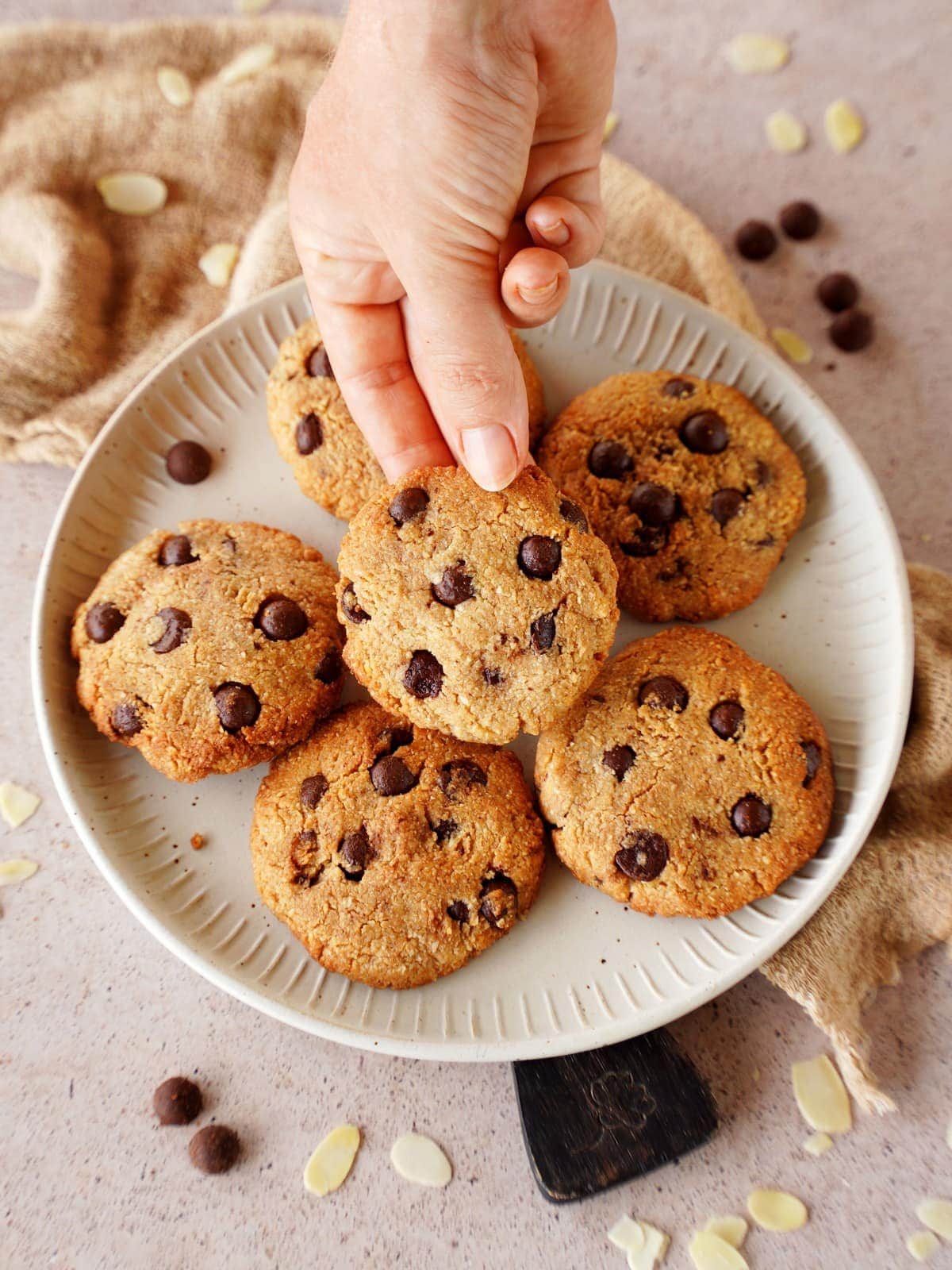 hand grabbing an almond flour chocolate chip cookie