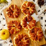 top shot of puff pastry apple rings on wooden board